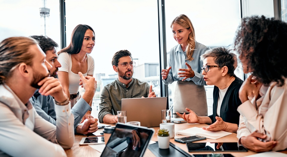 Good business idea. Inspired coworkers generating proposition for growing department's result. Enthusiastic women and men discussing project at meeting with excited facial expression.